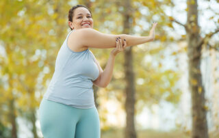 round woman exercising outdoors